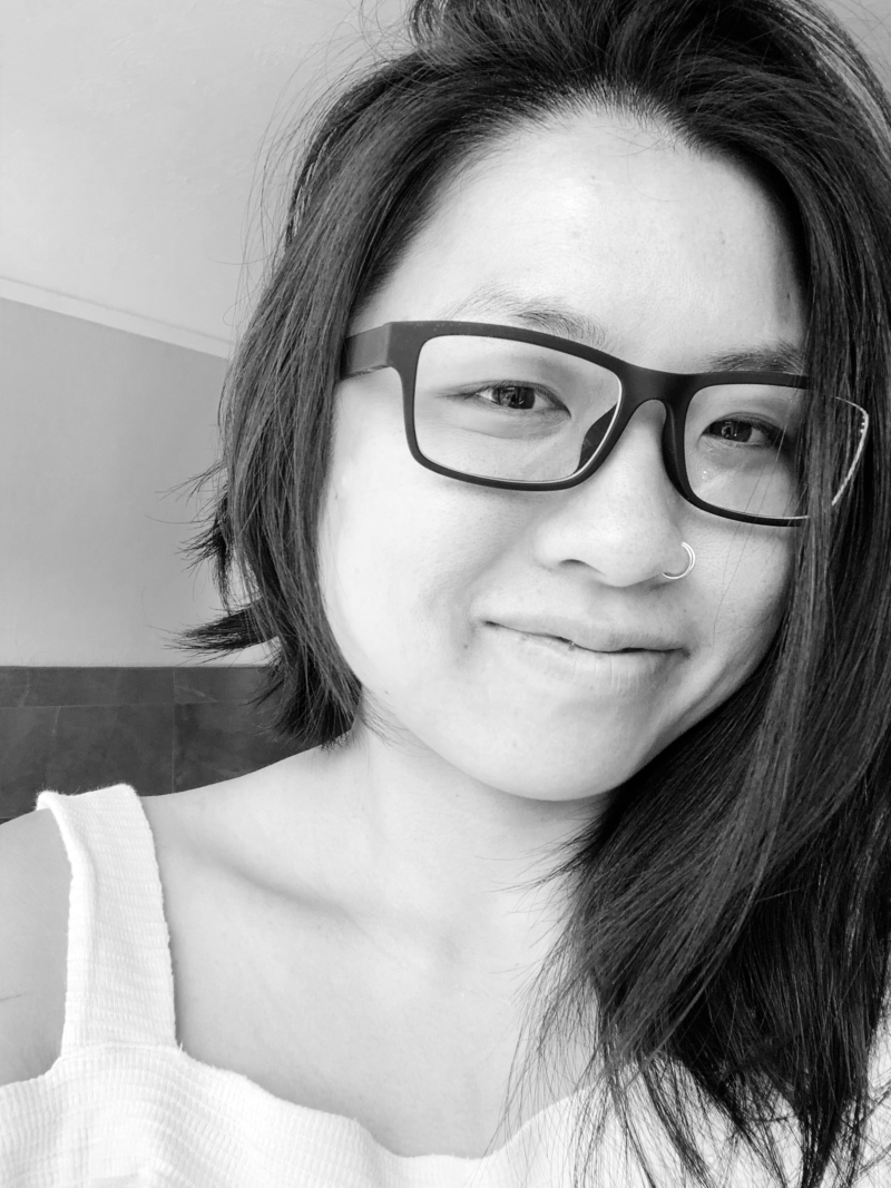 Stephanie Andrews smiling at the camera with glasses, dark hair and a white shirt.